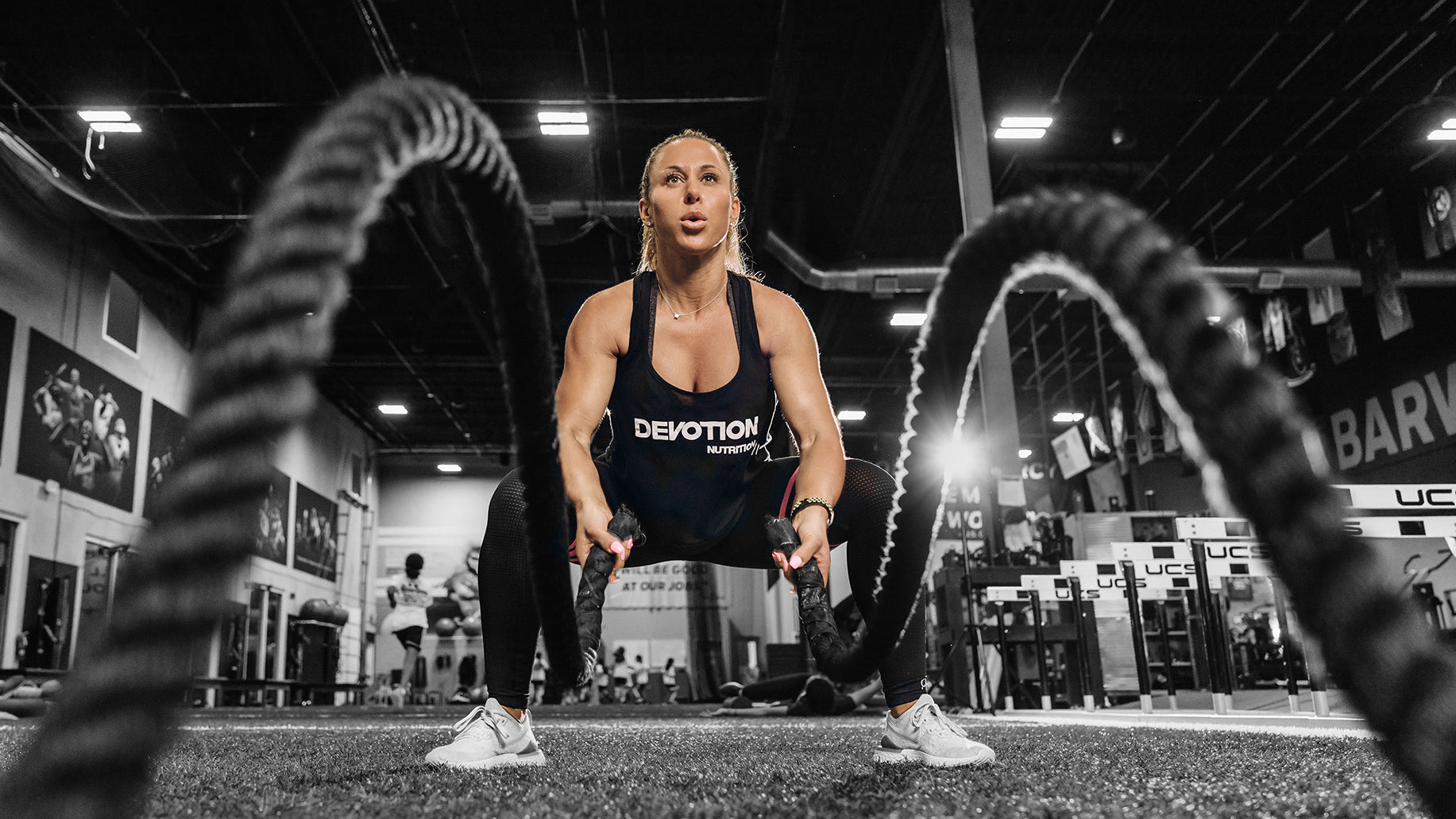 Dana Lynn Kaye training with battle ropes wearing Devotion Nutrition workout gear.