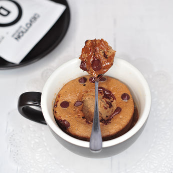 Devotion Nutrition Mocha Java Chip protein powder package with a chocolate shake.