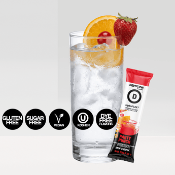 A Devotion Nutrition HydroFLEX Party Punch flavored drink mix pouch shown with a single stick pack and a glass of iced drink garnished with fruit on a light gray background.