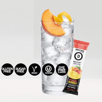 A Devotion Nutrition HydroFlex Peach Mango flavored water and smoothie enhancer pack shown with a large 12-count bag a single stick packet and a glass of iced water garnished with peach slices on a light gray background.