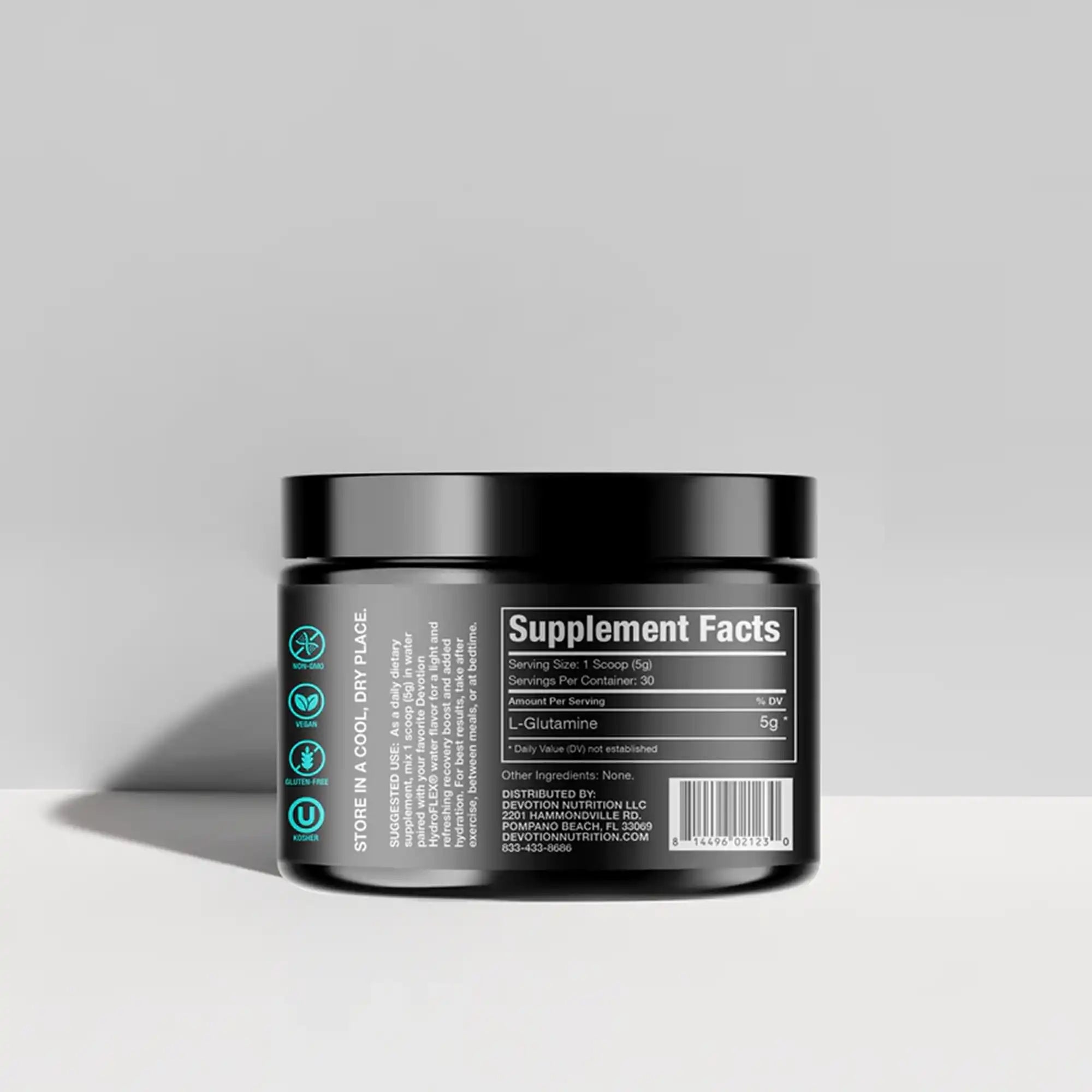 Black supplement container with label on a gray background