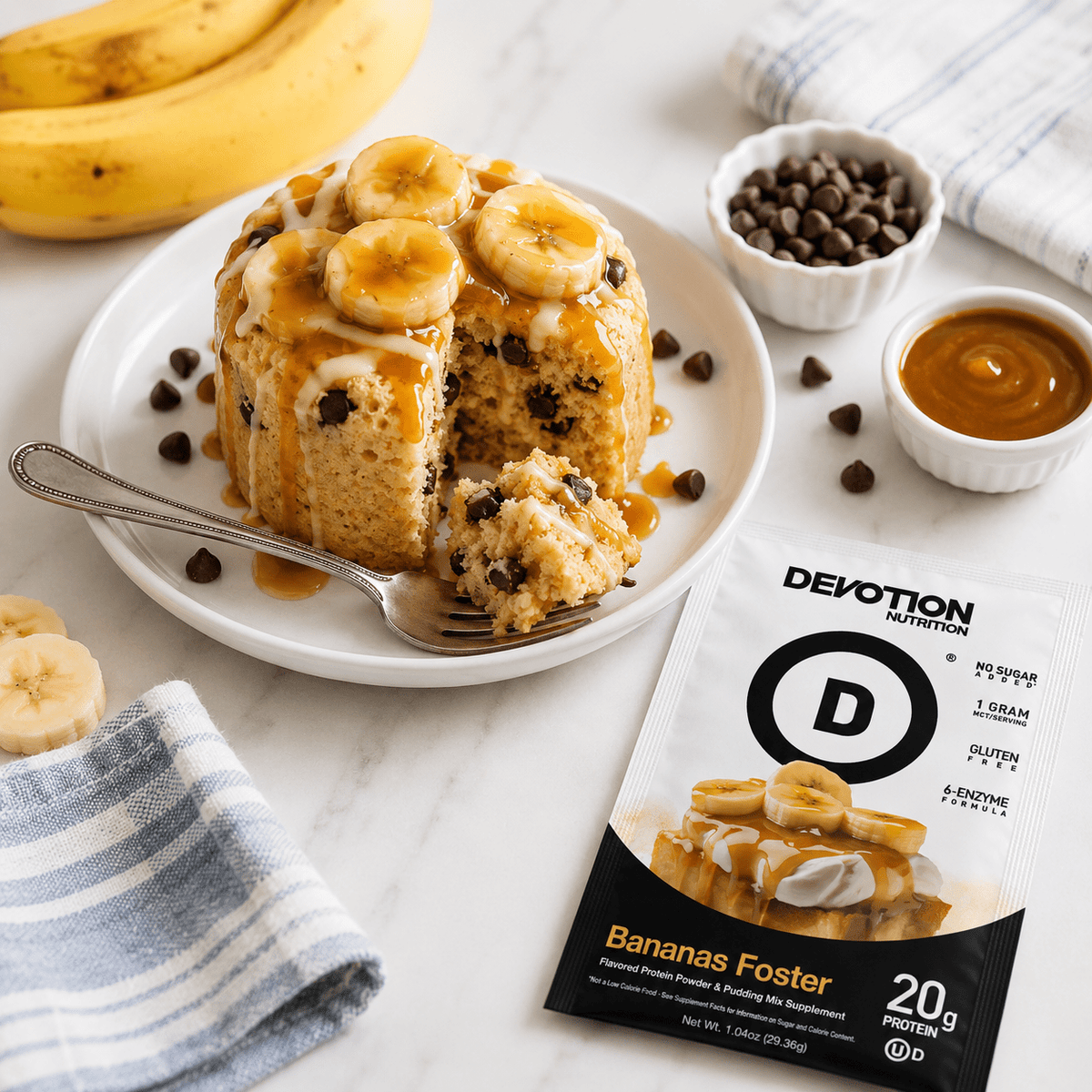 Bananas Foster dessert with a spoon on a plate, surrounded by ingredients and Devotion Nutrition protein powder package.