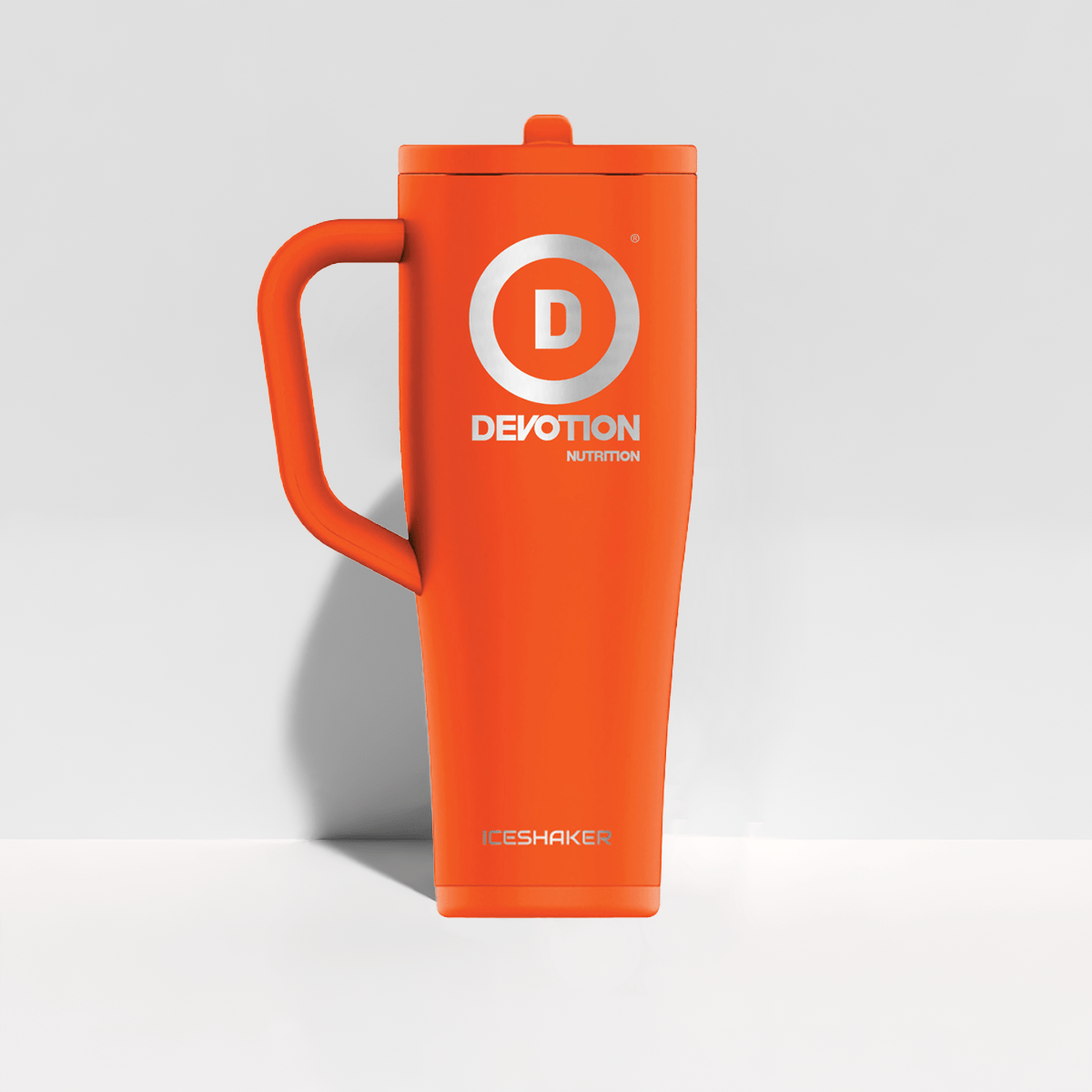 Orange mug with 'Devotion Nutrition' logo on a light gray background
