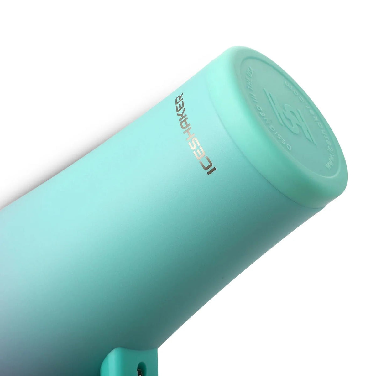 Close-up of a mint green insulated tumbler or bottle showing the silicone base against a white background.