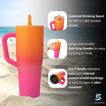 A tall insulated travel mug with a lid and handle  featuring a bright orange-to-pink gradient body. The front has a large silver circular 'D' logo with the word 'DEVOTION NUTRITION' underneath  and 'ICESHAKER' near the bottom.