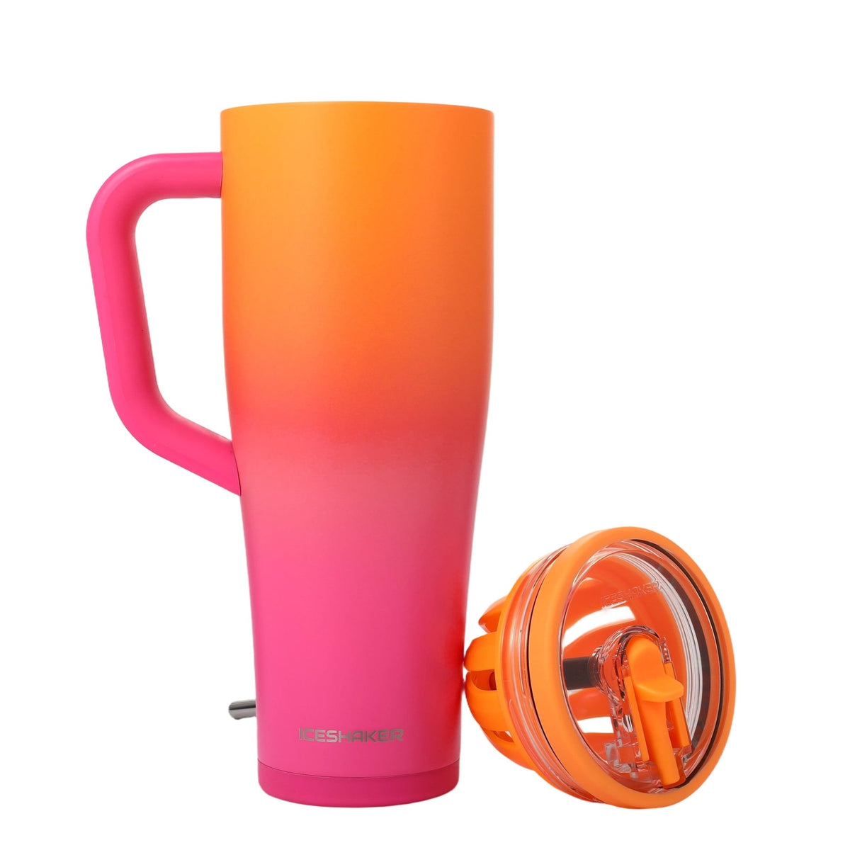 A tall insulated travel mug with a handle, featuring a vibrant orange-to-pink gradient body. The mug is shown alongside its detached orange lid, which is placed on a clean white background.