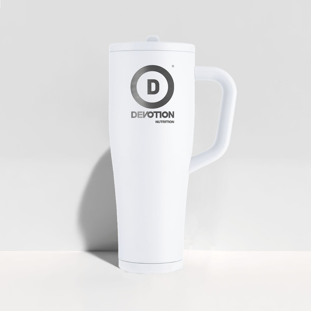 White mug with 'Devotion Nutrition' logo on a light gray background