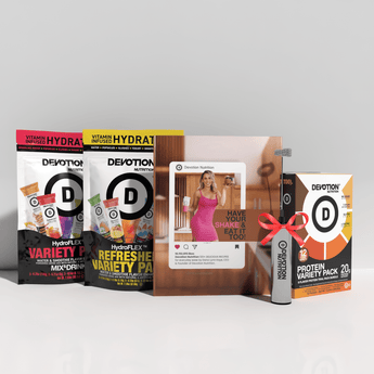 Collection of Devotion Nutrition products including protein packs and a magazine on a white background