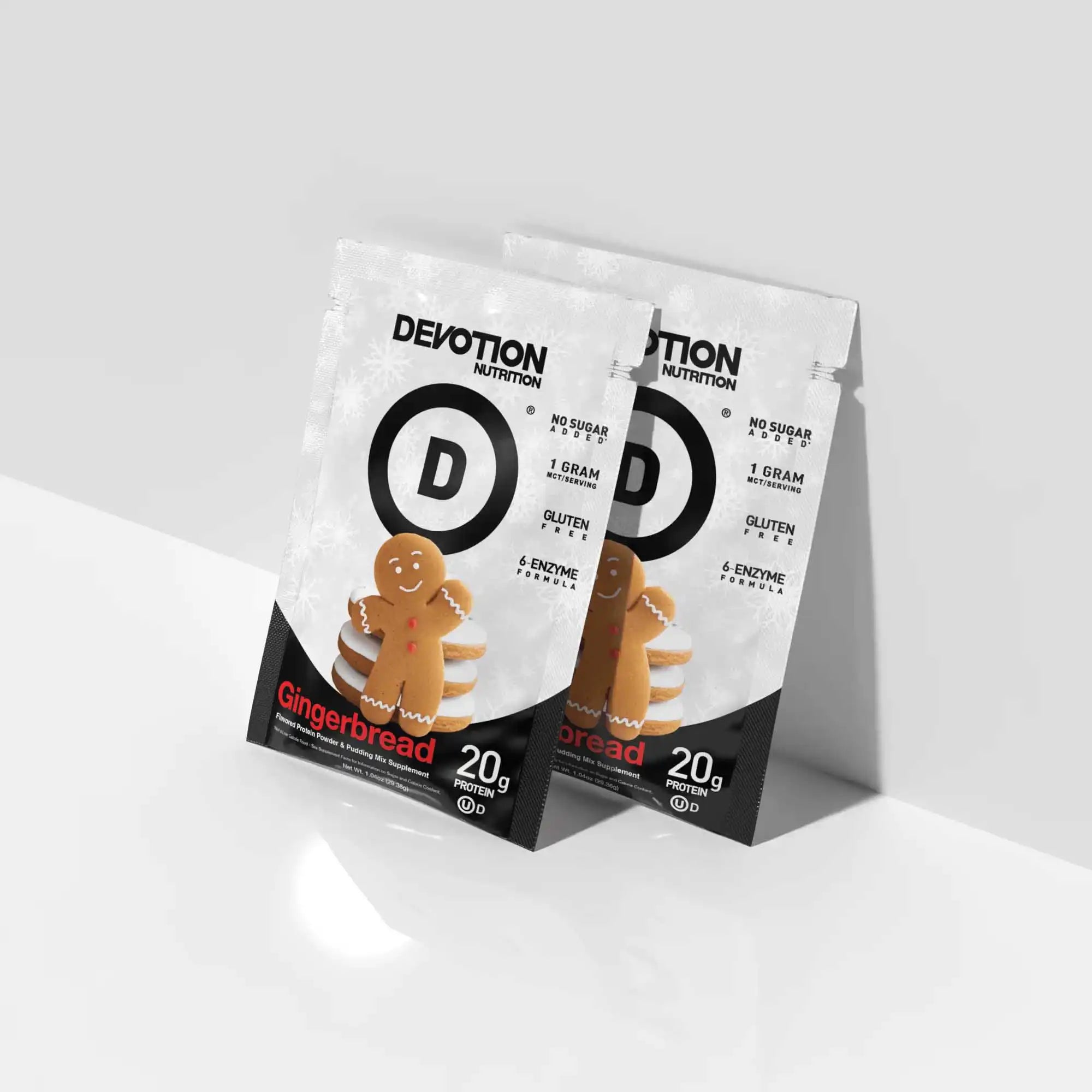 Two Devotion Nutrition gingerbread protein powder packages on a white background