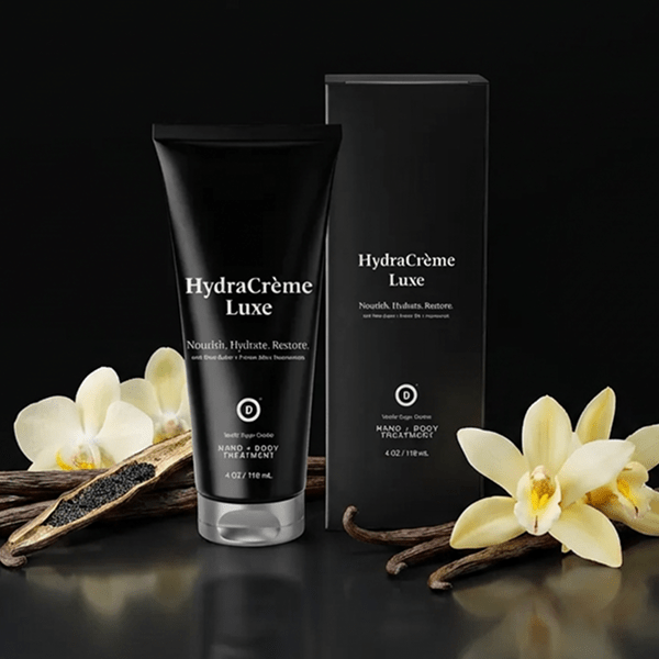HydraCreme Luxe product with packaging and vanilla beans on a dark background