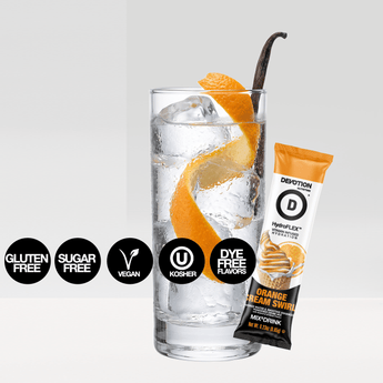 Devotion Nutrition HydroFlex Orange Cream Swirl flavored water and smoothie enhancer  shown as a large bag with a smaller single-serve stick pack beside it  with a glass of water  orange slices  and vanilla beans on a light gray background.