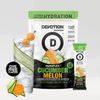 A Devotion Nutrition HydroFLEX Cucumber Melon flavored water and smoothie enhancer pouch shown with a single stick pack and a glass of water with cucumber and orange slices, on a light gray background.