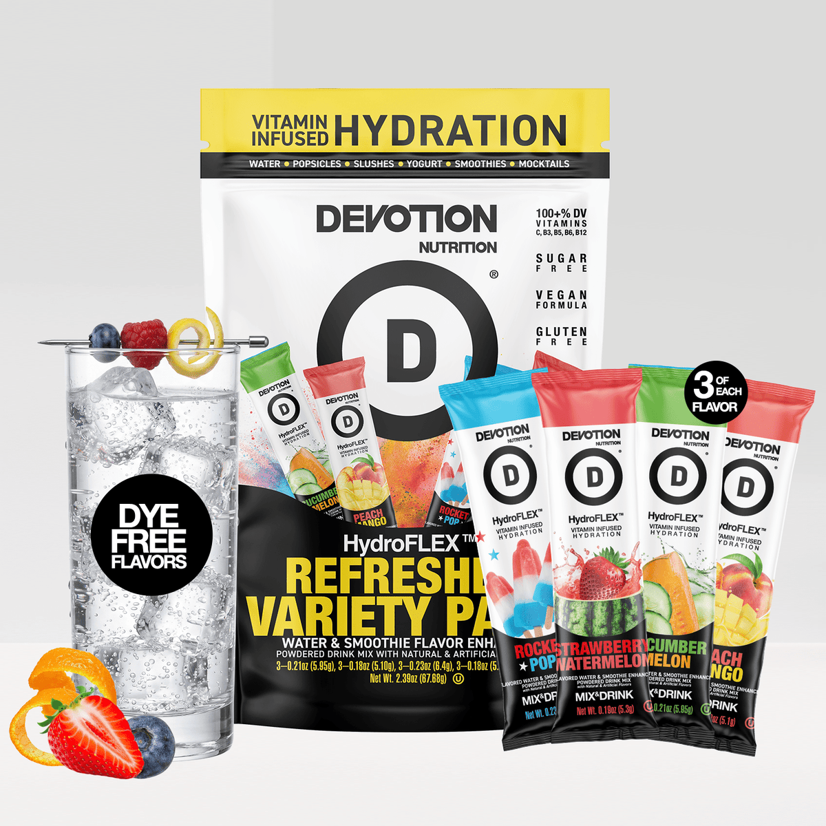 Devotion Nutrition HydroFlex Refreshing Variety Pack drink mix shown with a large black-and-yellow bag and four single-serve packets in blue, red, green, and orange flavors, alongside a glass of iced water with fruit garnish on a light gray background.