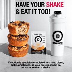 Devotion Nutrition | Protein Variety 12-Pack Bundle carousel slide with the headline Have Your Shake & Eat It Too, showing a packet of Devotion angel food cake protein powder and a shake in a devotion shaker and a stack of banana nut muffins to the left of the packet. Devotion is specially formulated to shake, bake, blend or freeze into delicious treats. 